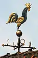 A rooster weather vane (also called a weathercock)