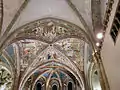 A simple ribbed arch decorated with fresco in Italy.