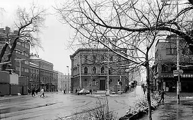 People hurry across a street called "Sniper Alley."  Serbian soldiers would shoot people as they crossed the street