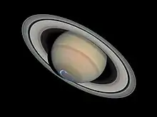 Saturn with an aurora, circular in shape, blue, located in the South Pole of Saturn.