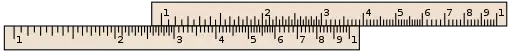 A slide rule, aligned to calculate x÷5.5