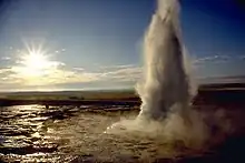 Water erupting into the air from a pool.