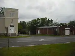 A view of Stull looking southwest. The building on the left is the former United Methodist Church, and the building on the right is an abandoned store.