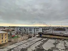 The depth of the city of Balkhash. A lake and a copper plant are visible in the background.