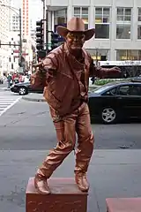 A living statue performer. Living statue performers act as if they are statues.