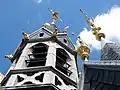 Clock tower in Belgium with weather vanes