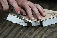 A soldier makes a charge of C4 to cut through solid steel at a destructions range