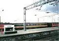 A picture of a Virgin Trains' MK 3 carriage at Crewe station in the year 2000. It is in its former Inter City livery. Most are now either renovated or scrapped. They were too old to use.