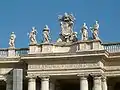 There are many statues on the colonnade and roof.