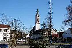 Market square with the Church of Saint John the Baptist and maypole