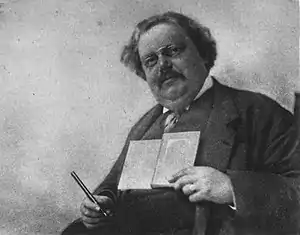 Chesterton Holding Book and Pen.jpg