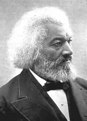 A profile view of Douglass, wearing a suit