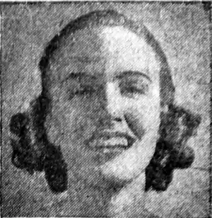 Black and white photograph of a smiling woman