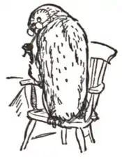 Owl seated on a chair, turning his head and licking a pencil