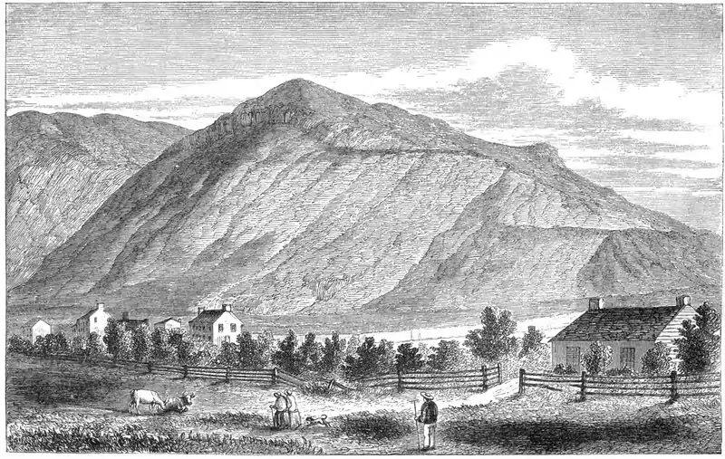 Engraving of a mountain with houses and pastoral figures in foreground