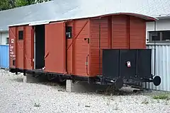 Photograph of a restored train car, with its sliding door open, used to transport Slovak Jews