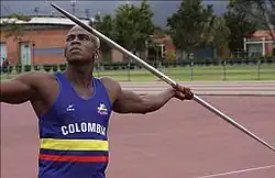 A man holding a javelin on an athletic track